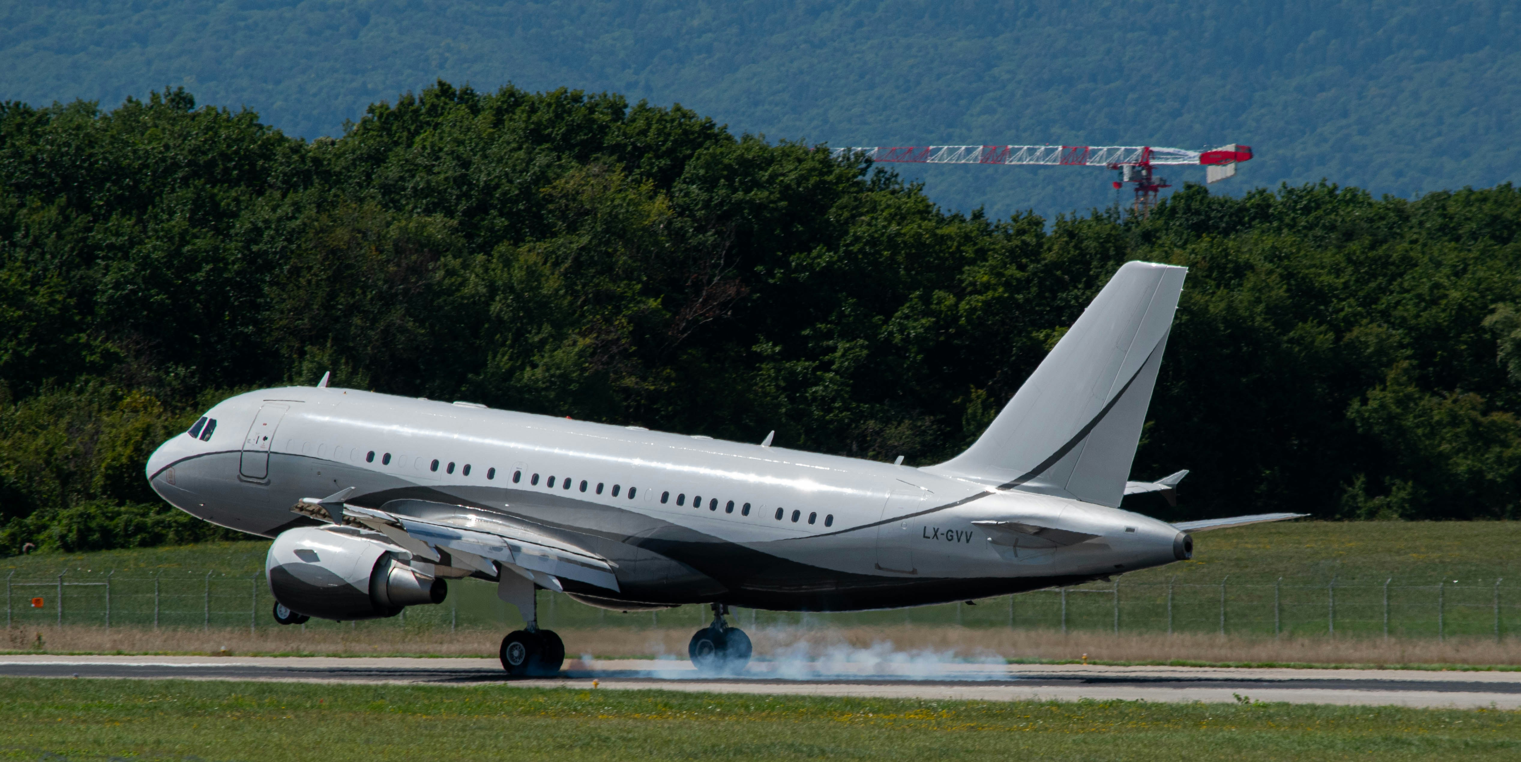 white passenger plane on the road